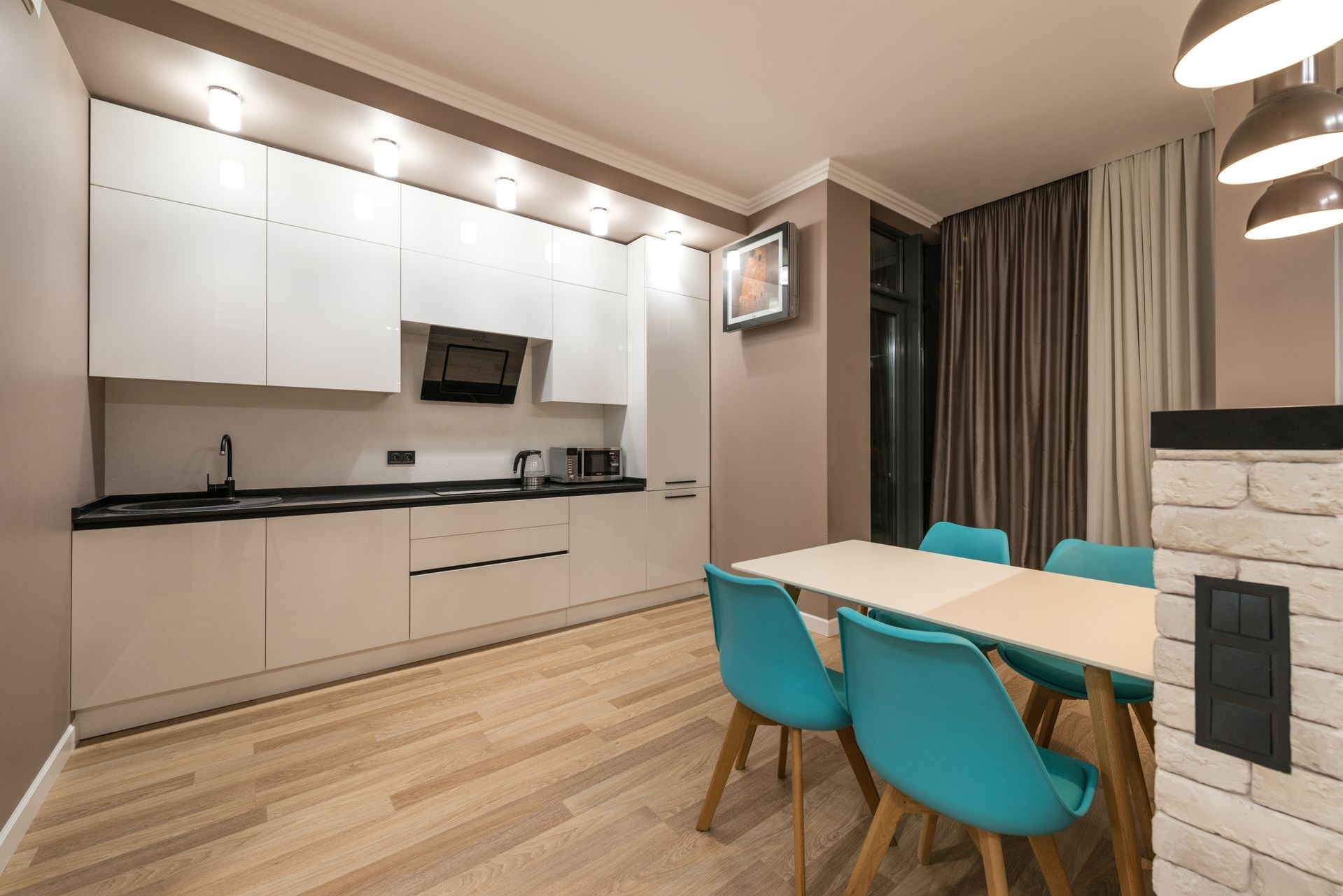 Modern kitchen and dining area with recessed downlights and pendant lighting installed - Cairns City Electrics, Cairns